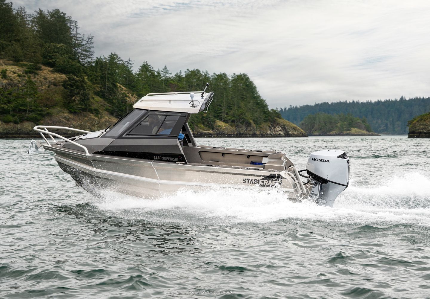 Silver Boat Speeding on Water Near Forested Shoreline — TJM Rockhampton in Rockhampton City, QLD