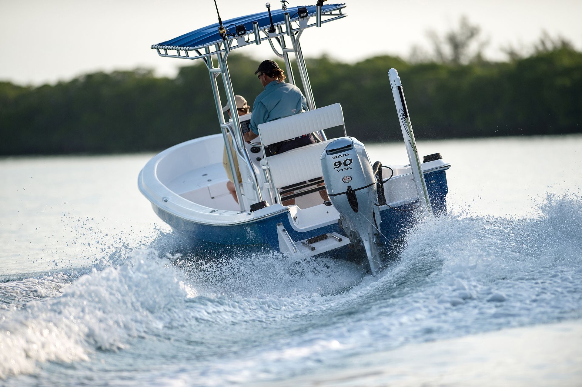 Small White and Blue Boat Speeding Across Water — TJM Rockhampton in Rockhampton City, QLD
