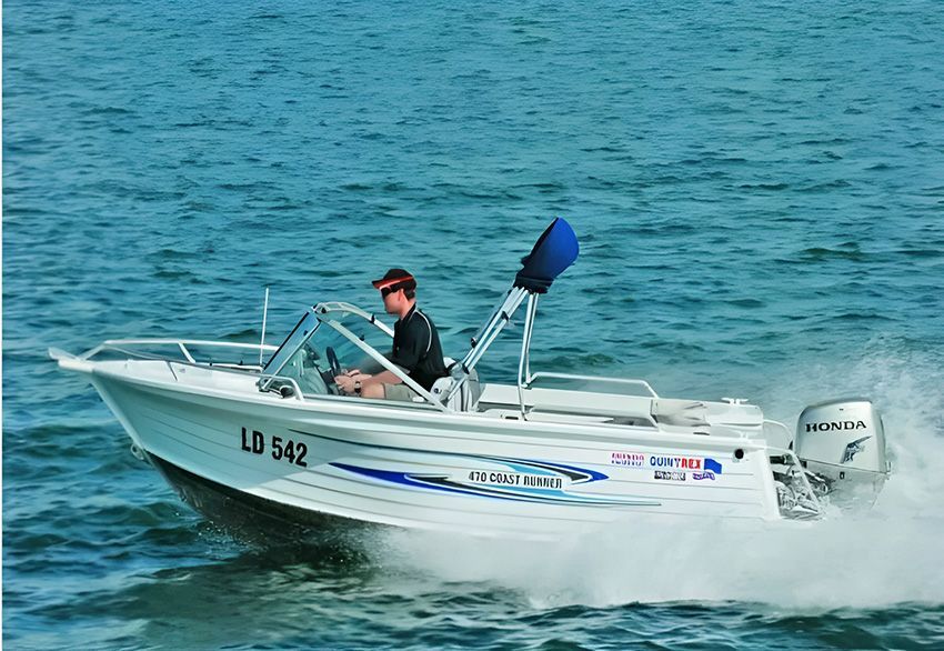 A Man is Driving a Boat — Mackay Marine Services in Mackay, QLD