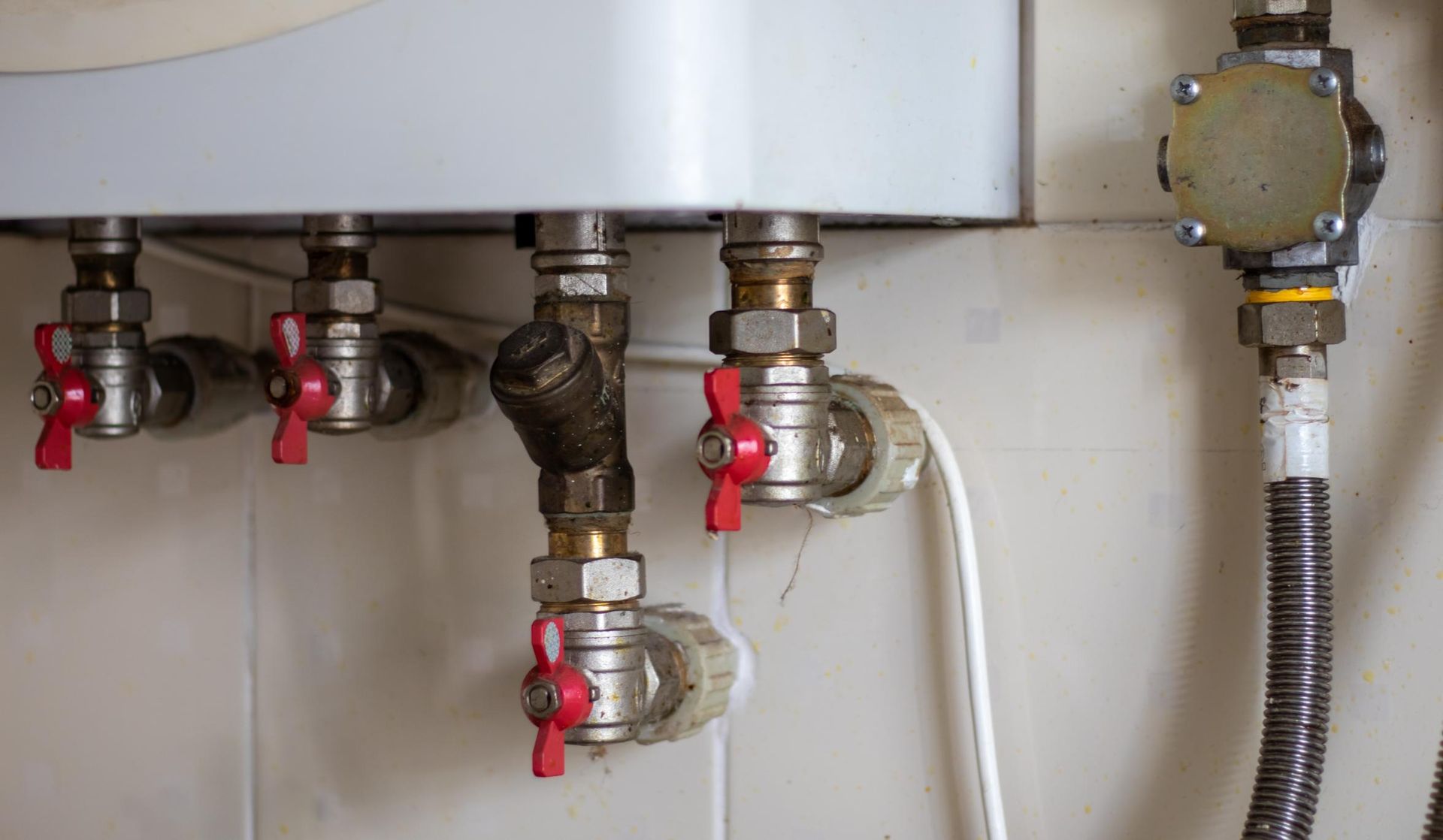 A Close Up of a Water Heater With Red Valves — Sparky Mid North Coast In Harrington, NSW