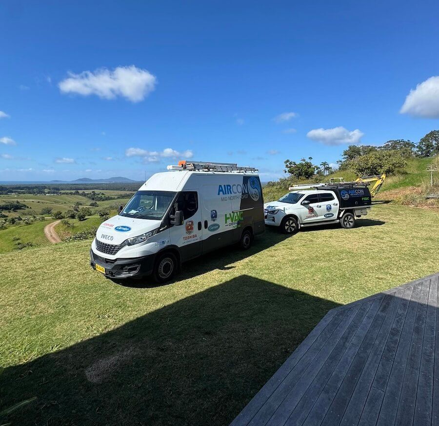 Two vans are parked on top of a grassy hill — Sparky Mid North Coast In Forster, NSW