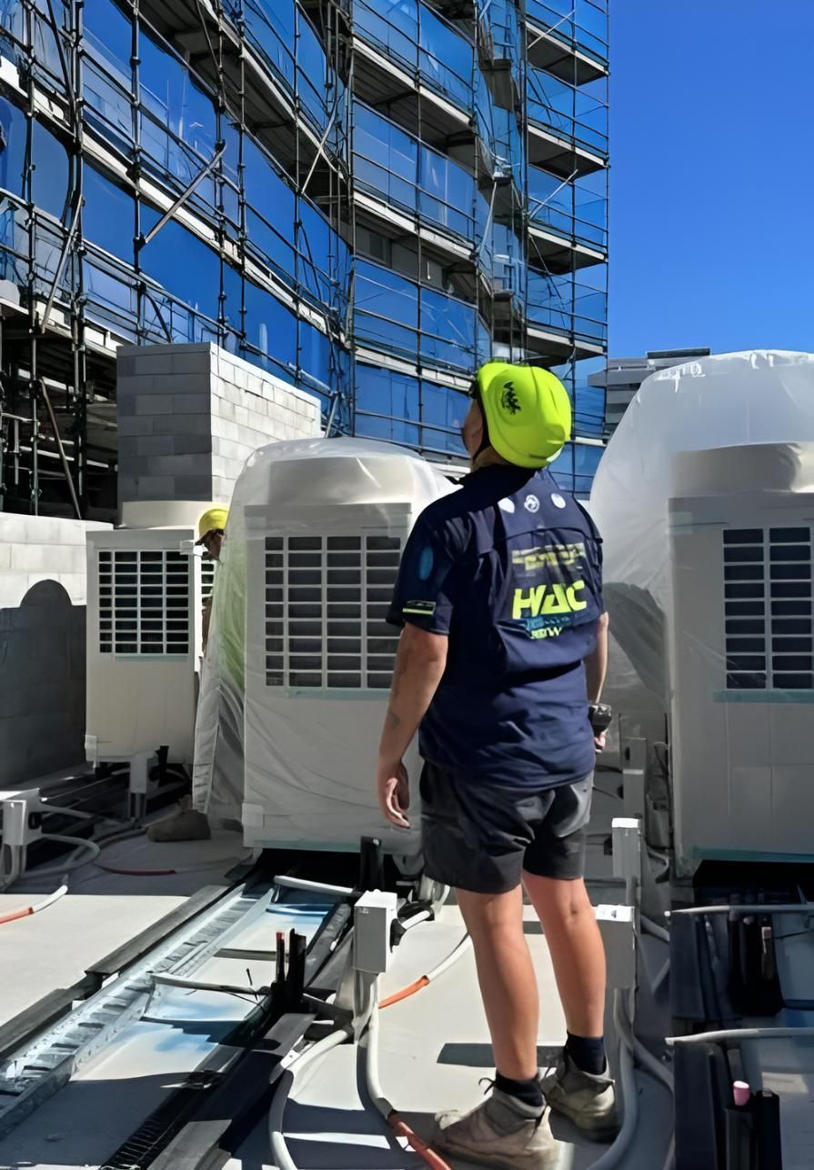 A Man is Sitting on a Cart With Pink Gas Cylinders — Sparky Mid North Coast In Forster, NSW