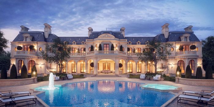 A large house with a swimming pool in front of it