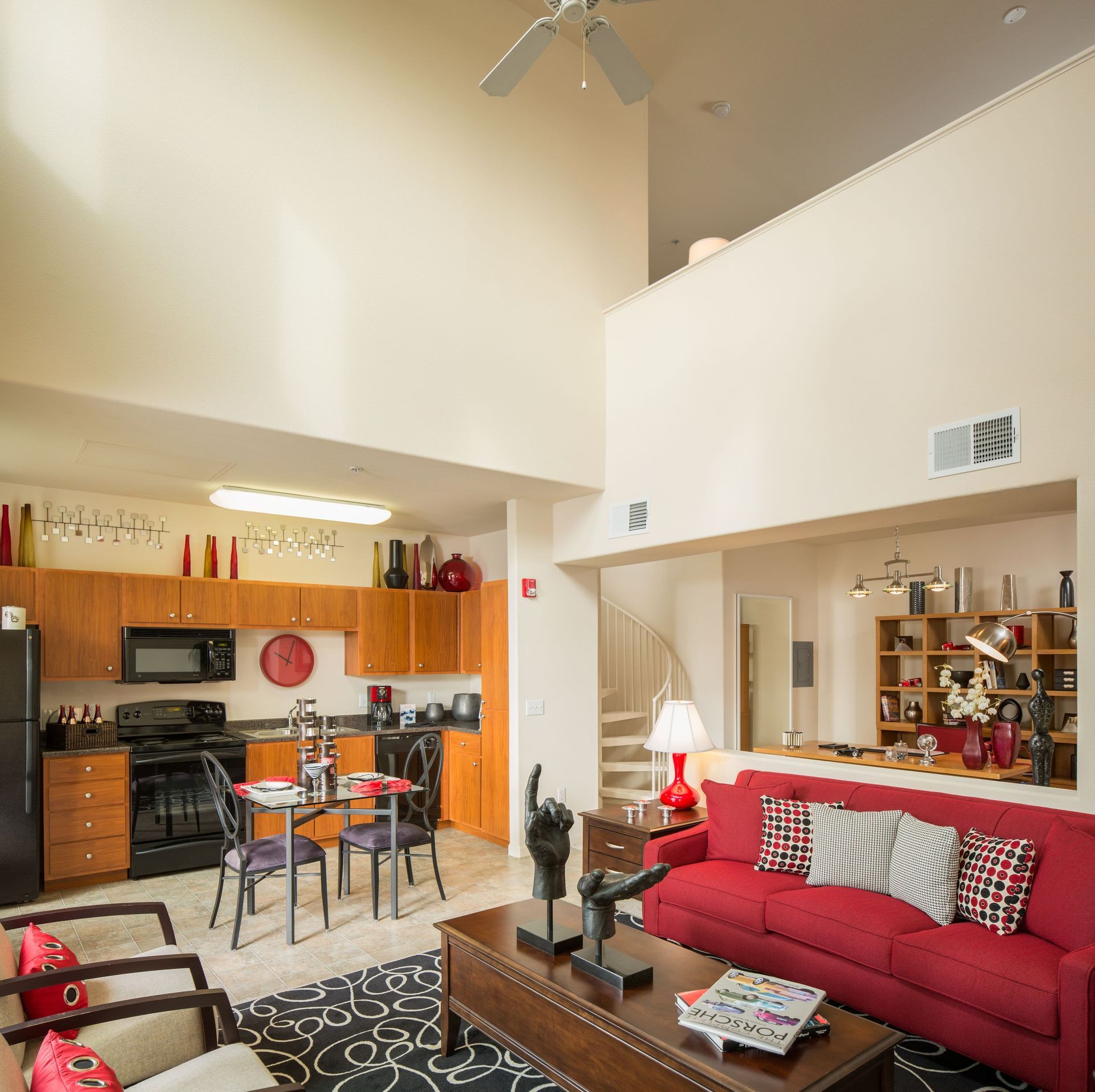 Open-concept living area with kitchen, red sofa, and dining table.