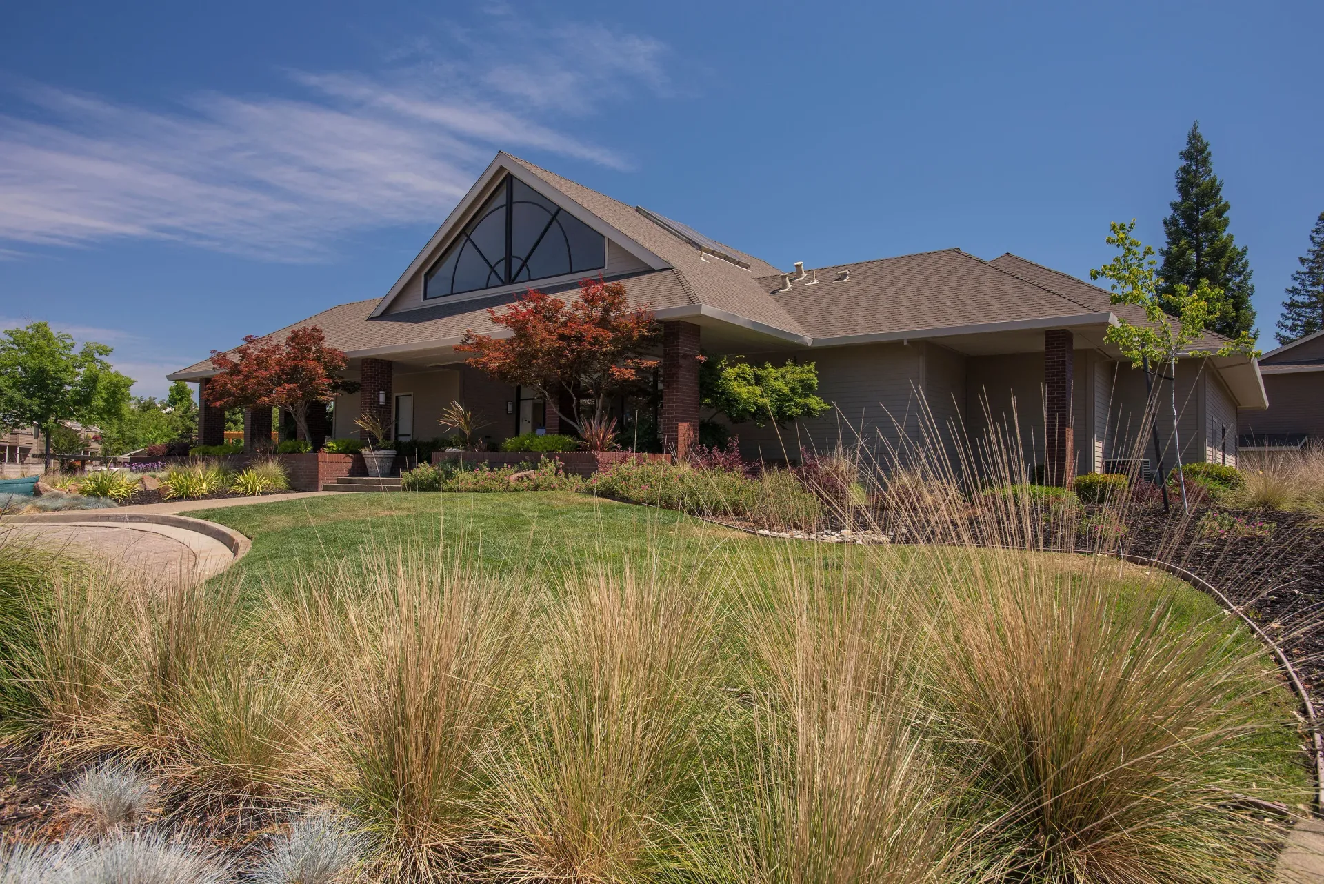 Exterior view of the apartment community with landscaped grounds and a walkway.