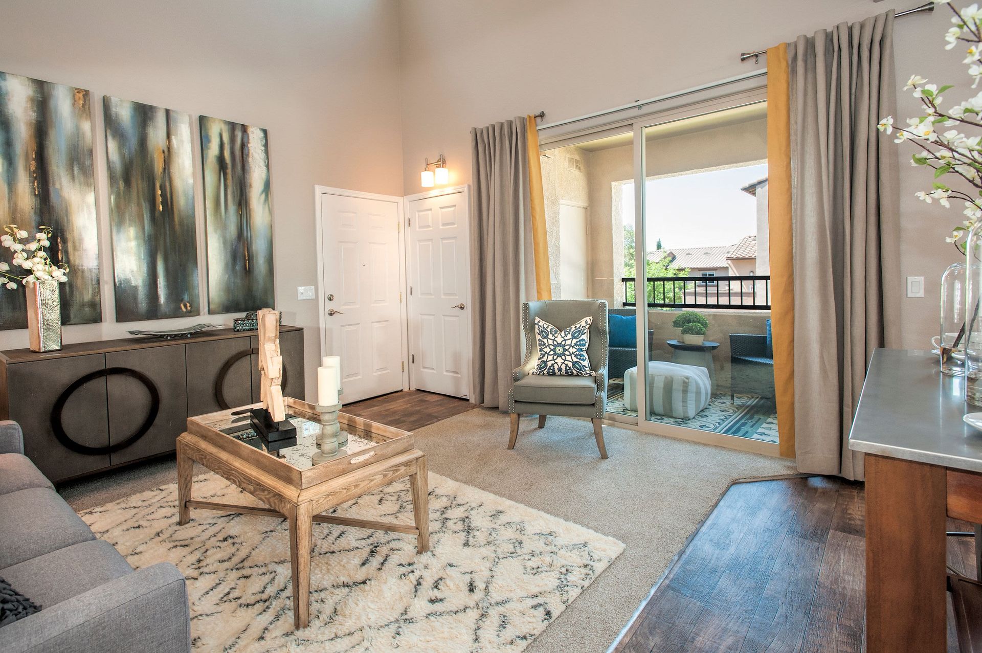 Contemporary living room with a sliding glass door to the balcony and seating area.