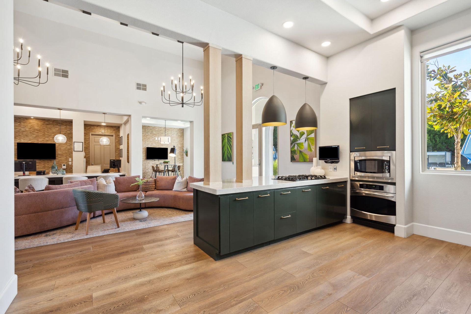 Open-concept kitchen with an island and stainless steel appliances in a modern apartment.