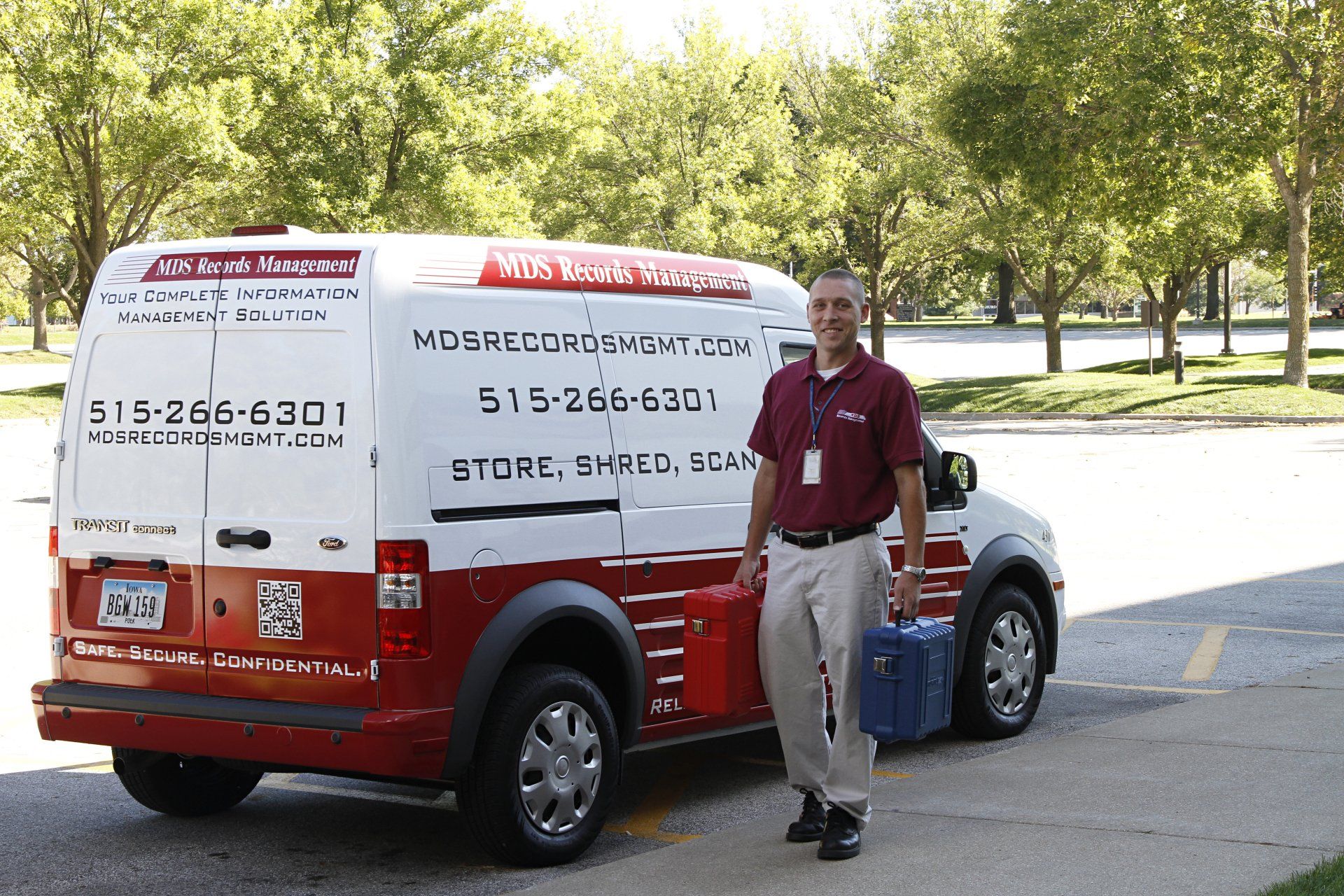 Man Holding Tool Box Behind The Van — Des Moines, IA — M D S Records Management