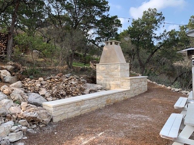 Fireplace with stone veneer, flanked by a doorway and wall cabinet in a living space with muted green walls.