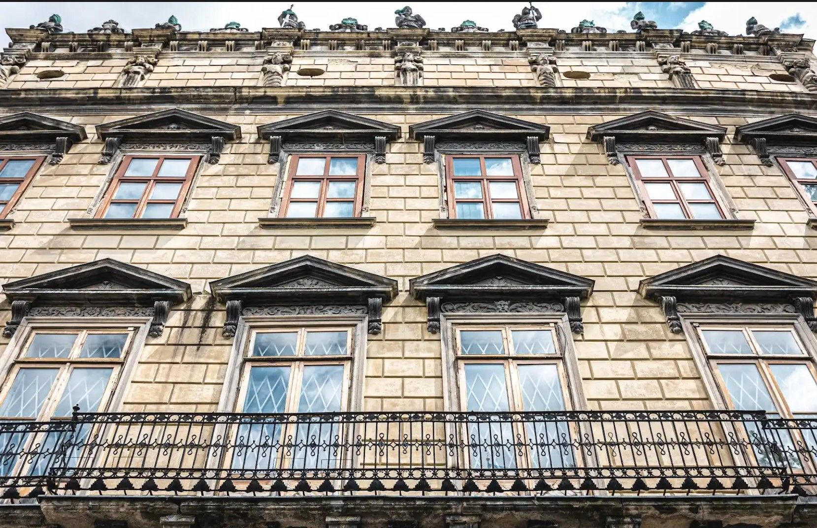 A large brick building with many windows and a balcony