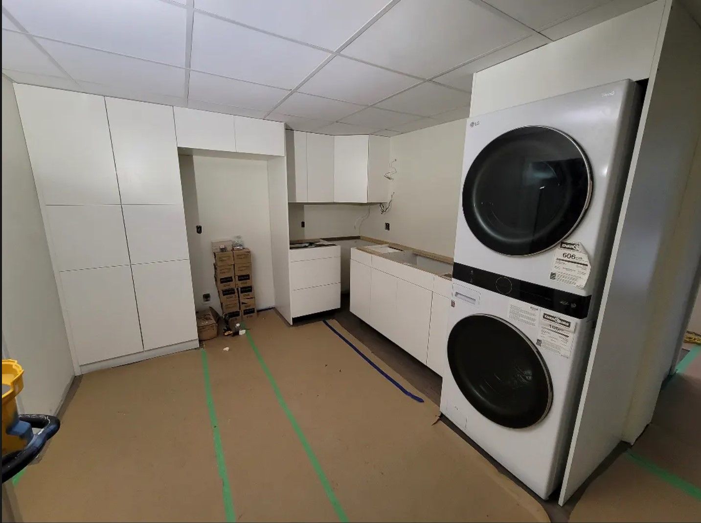A laundry room with a washer and dryer stacked on top of each other.