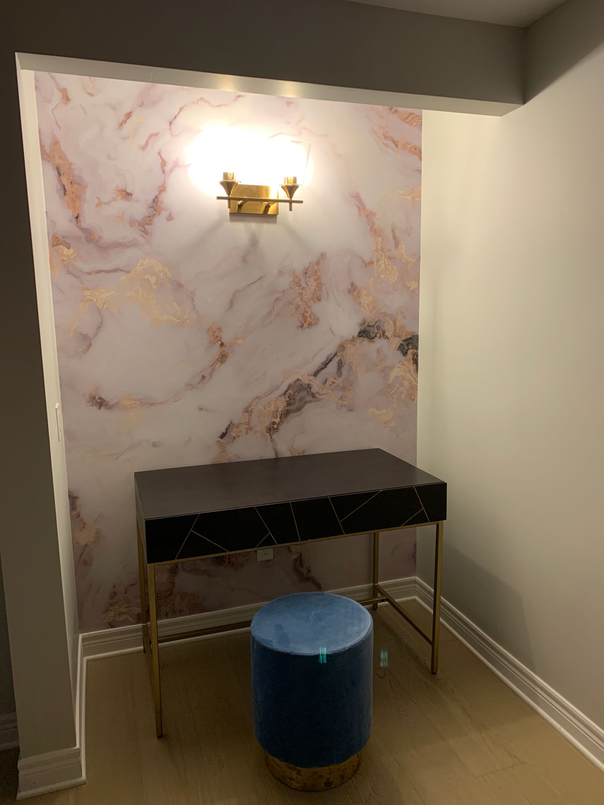 Two men are working on a wooden frame in a room.