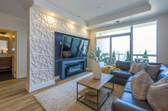 A living room with a couch , coffee table , television and fireplace.