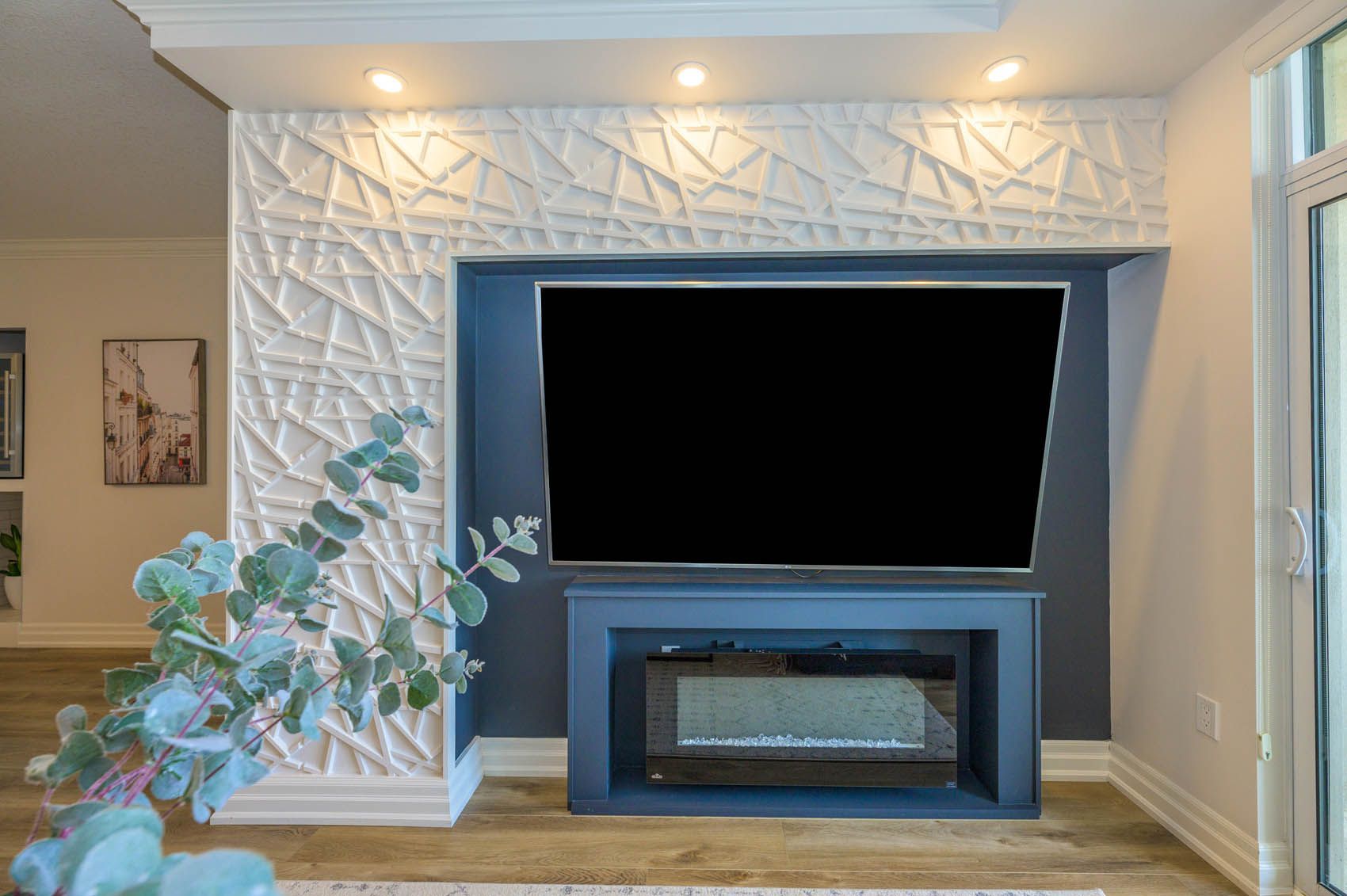 A living room with a fireplace and a flat screen tv.