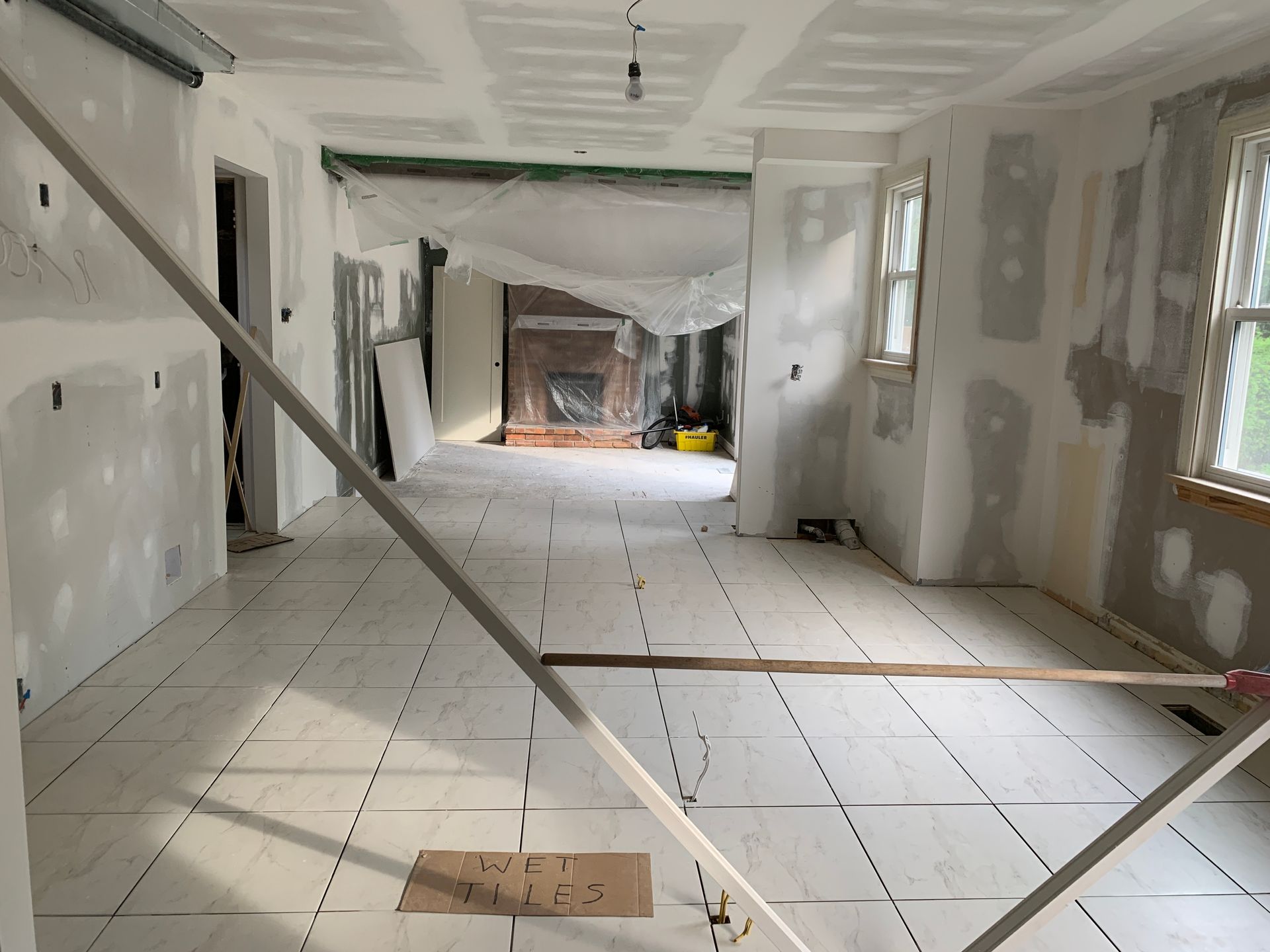 A room that is being remodeled with a sign on the floor that says 