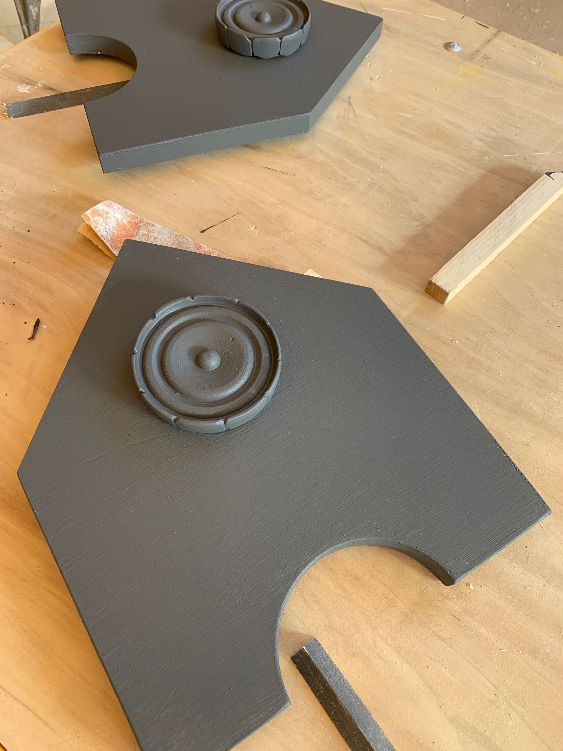 Two pieces of foam are sitting on a wooden table.