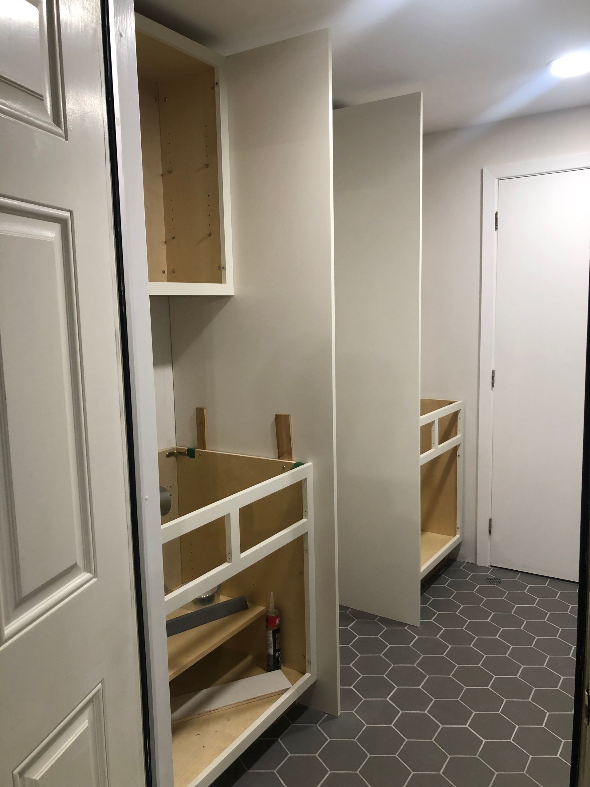 A room with a lot of cabinets and a door