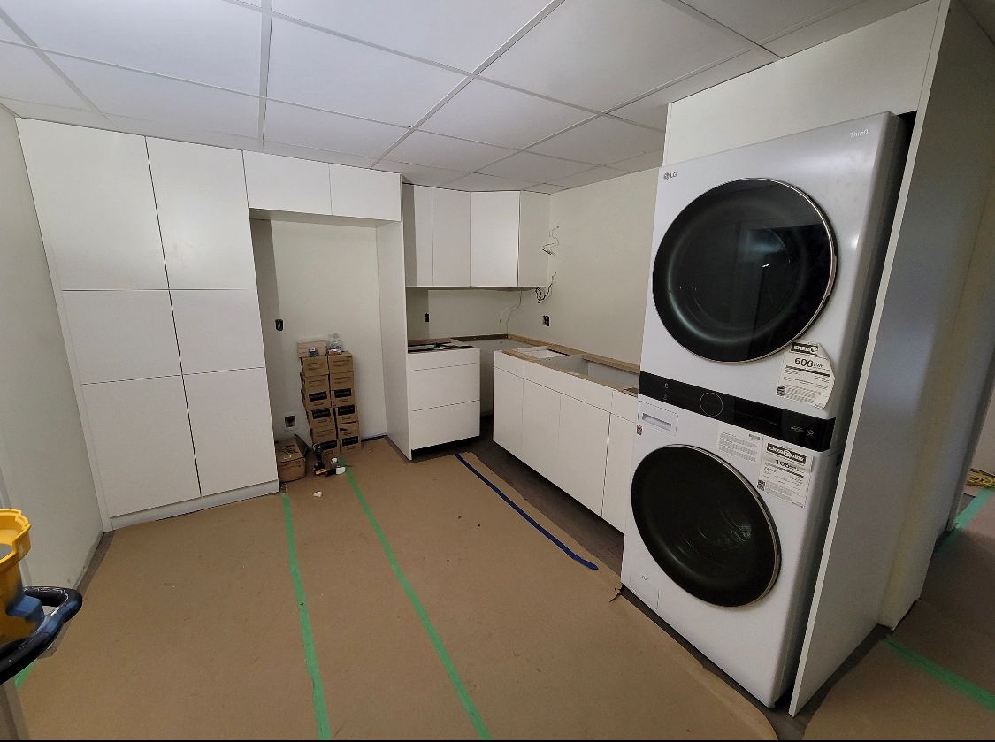 A laundry room with a washer and dryer stacked on top of each other.