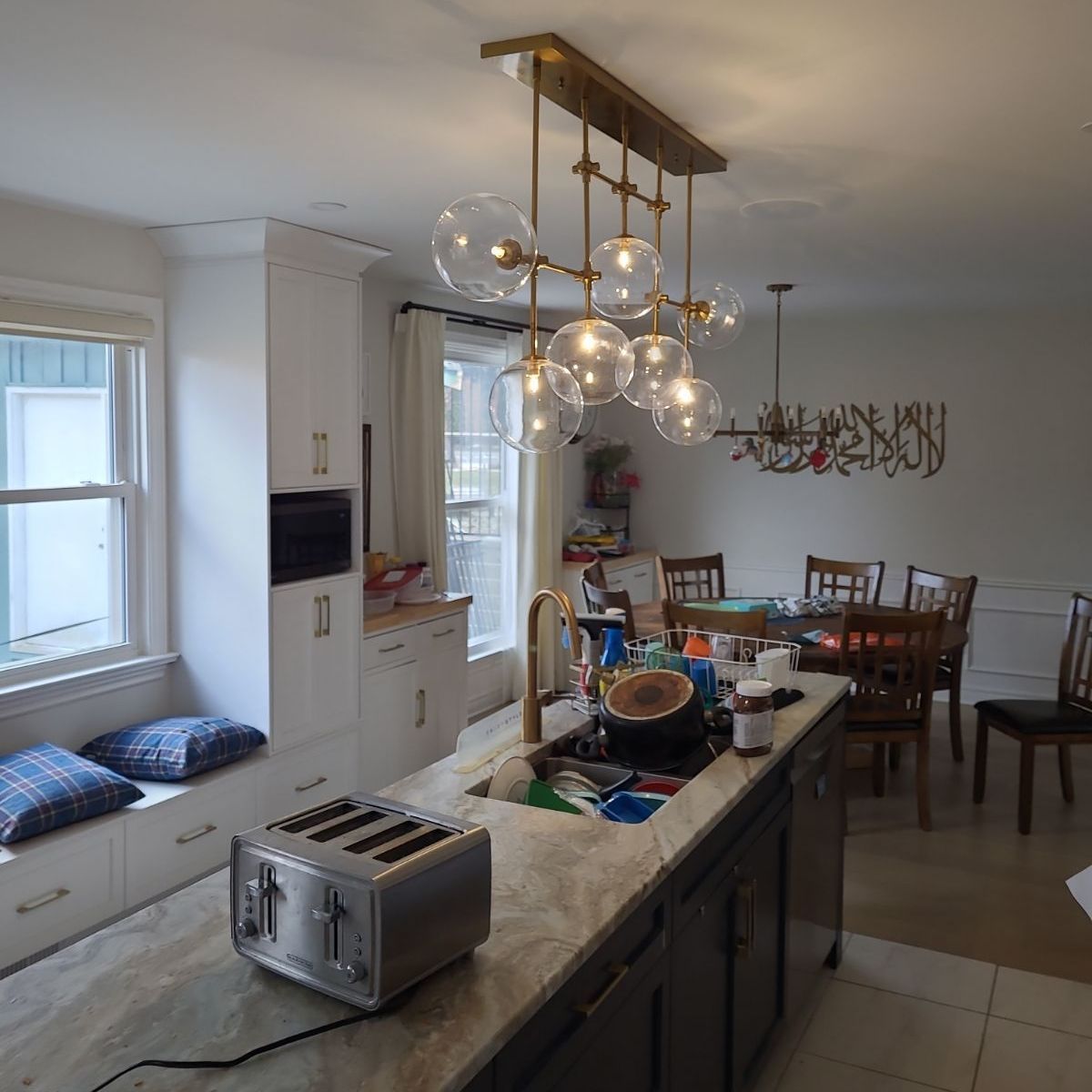 A kitchen with a sink and a toaster on the counter