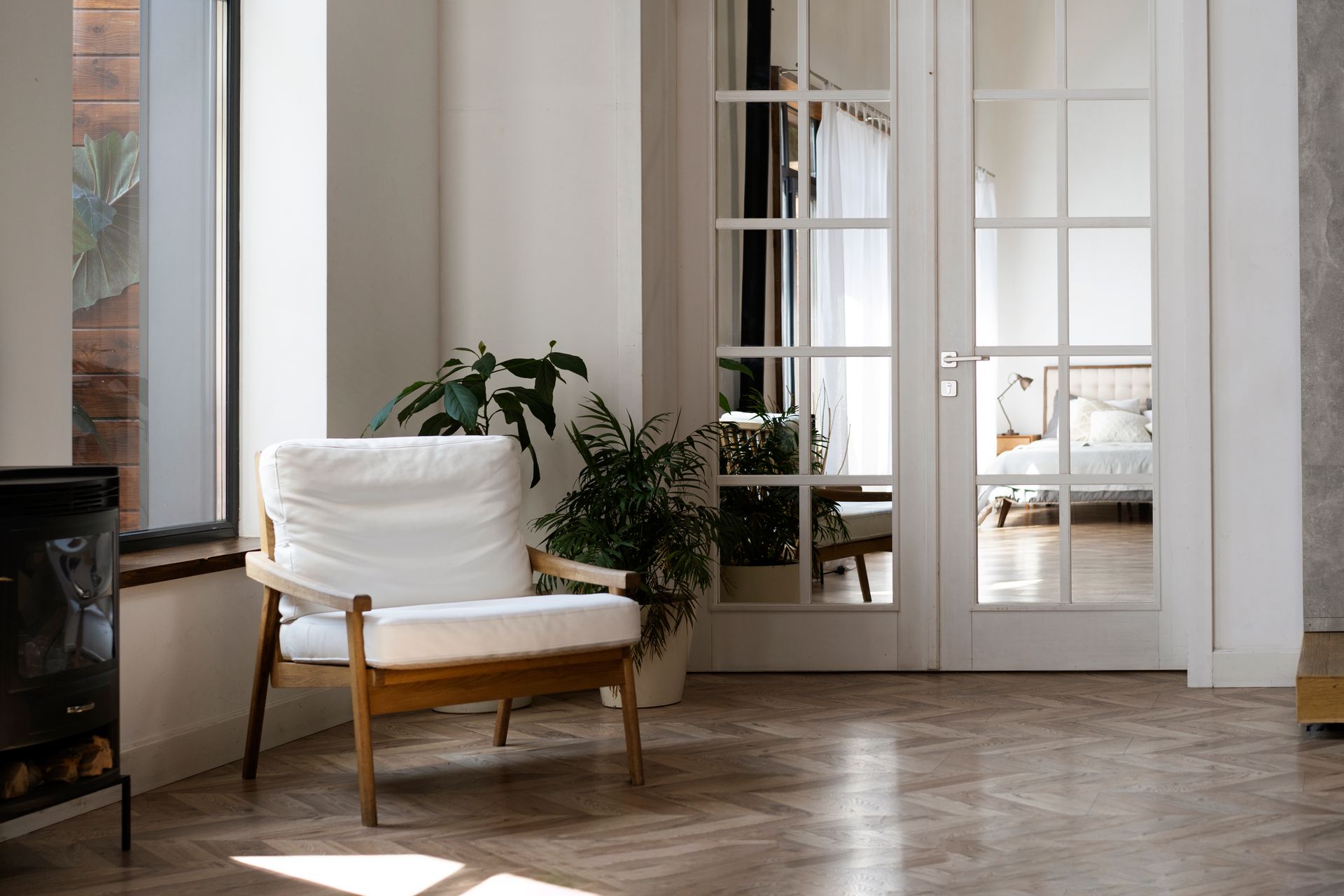 A dining room with a round table and chairs and a large window.