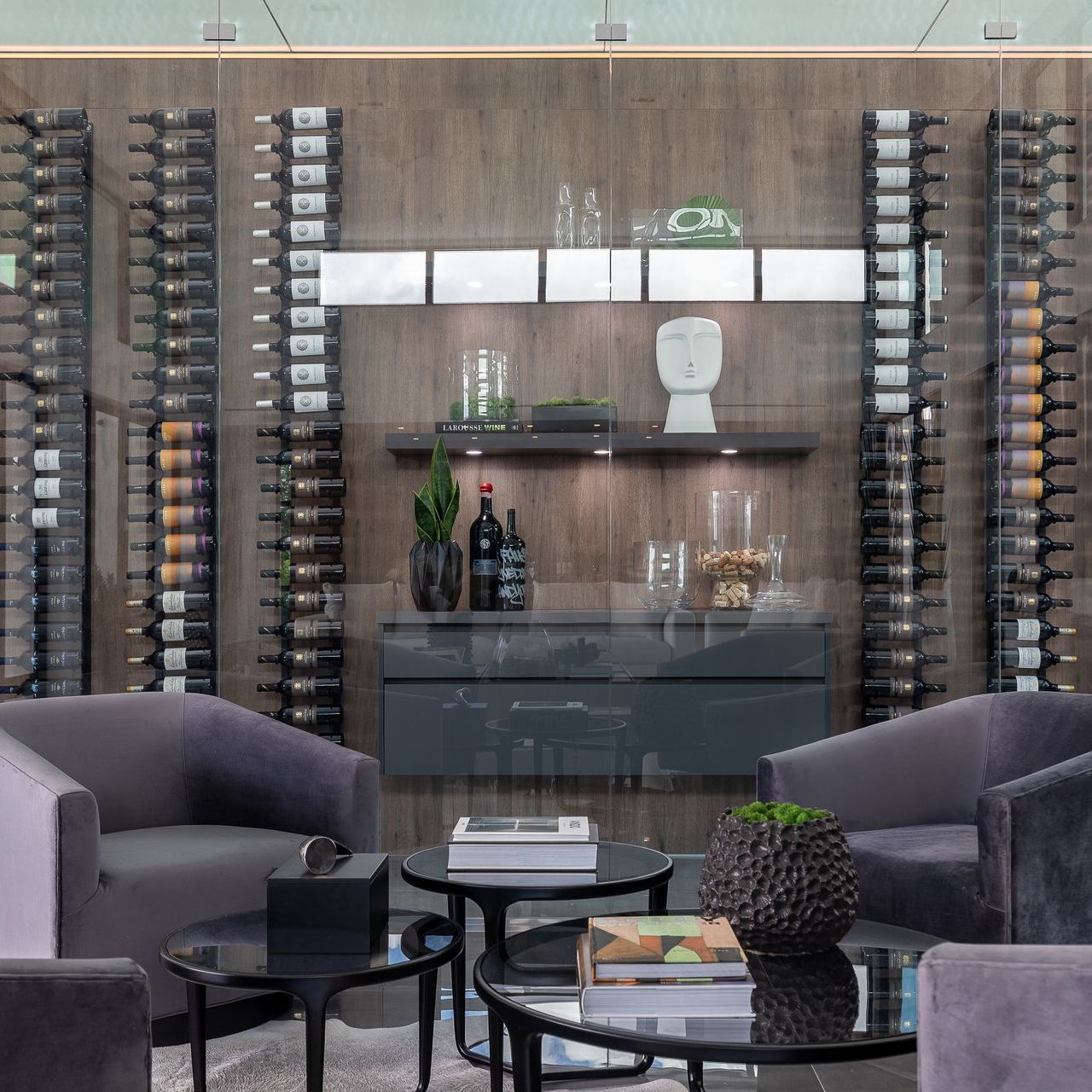 A living room filled with furniture and bottles of wine