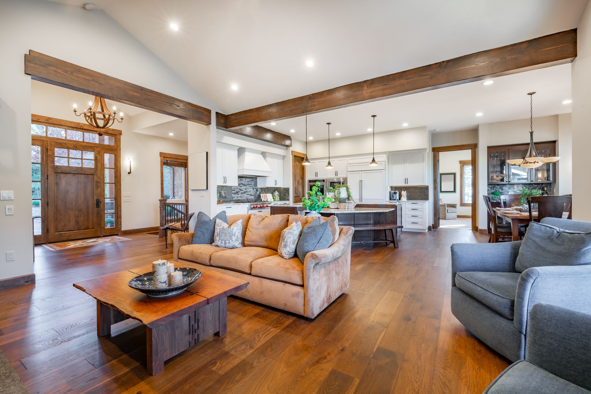 A living room with a couch , chairs , and a coffee table.