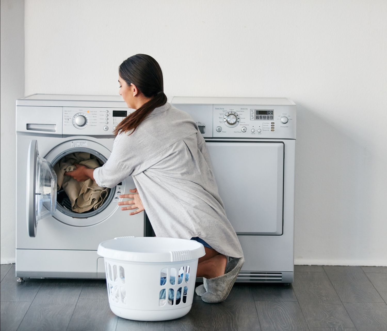 A white washing machine and dryer are in a laundry room.