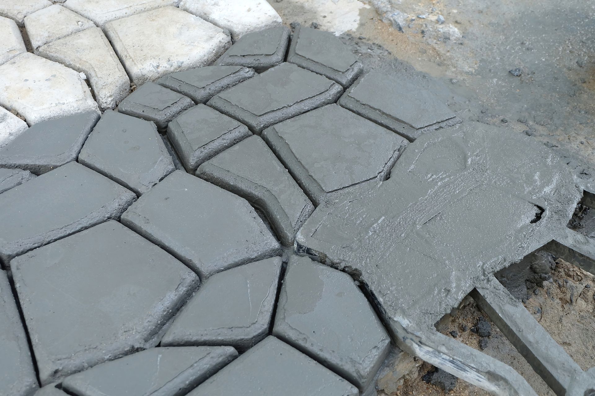 A brick walkway with steps leading up to a wooden deck