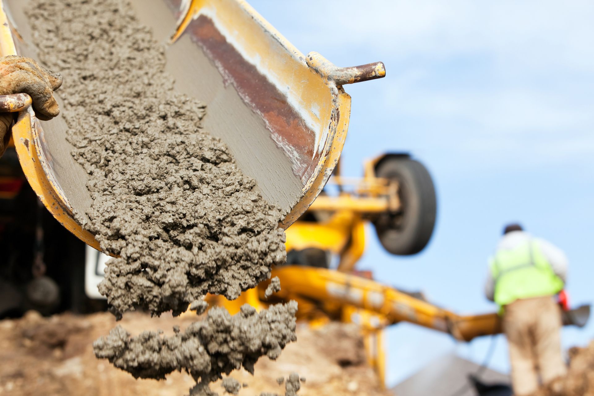 A man and a woman are shaking hands with a construction worker.