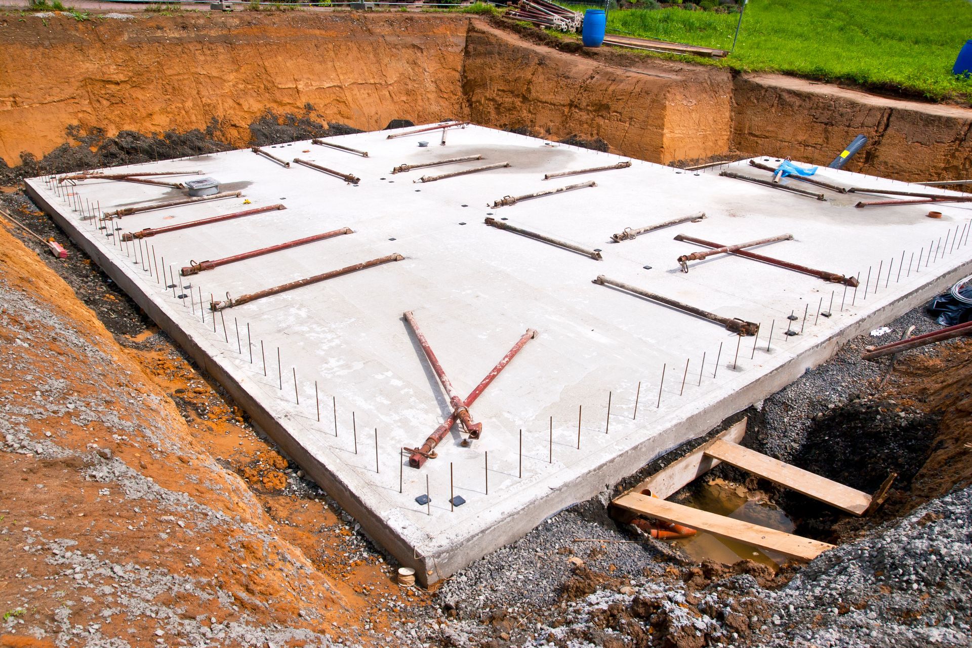 A large concrete slab is sitting on top of a dirt field.