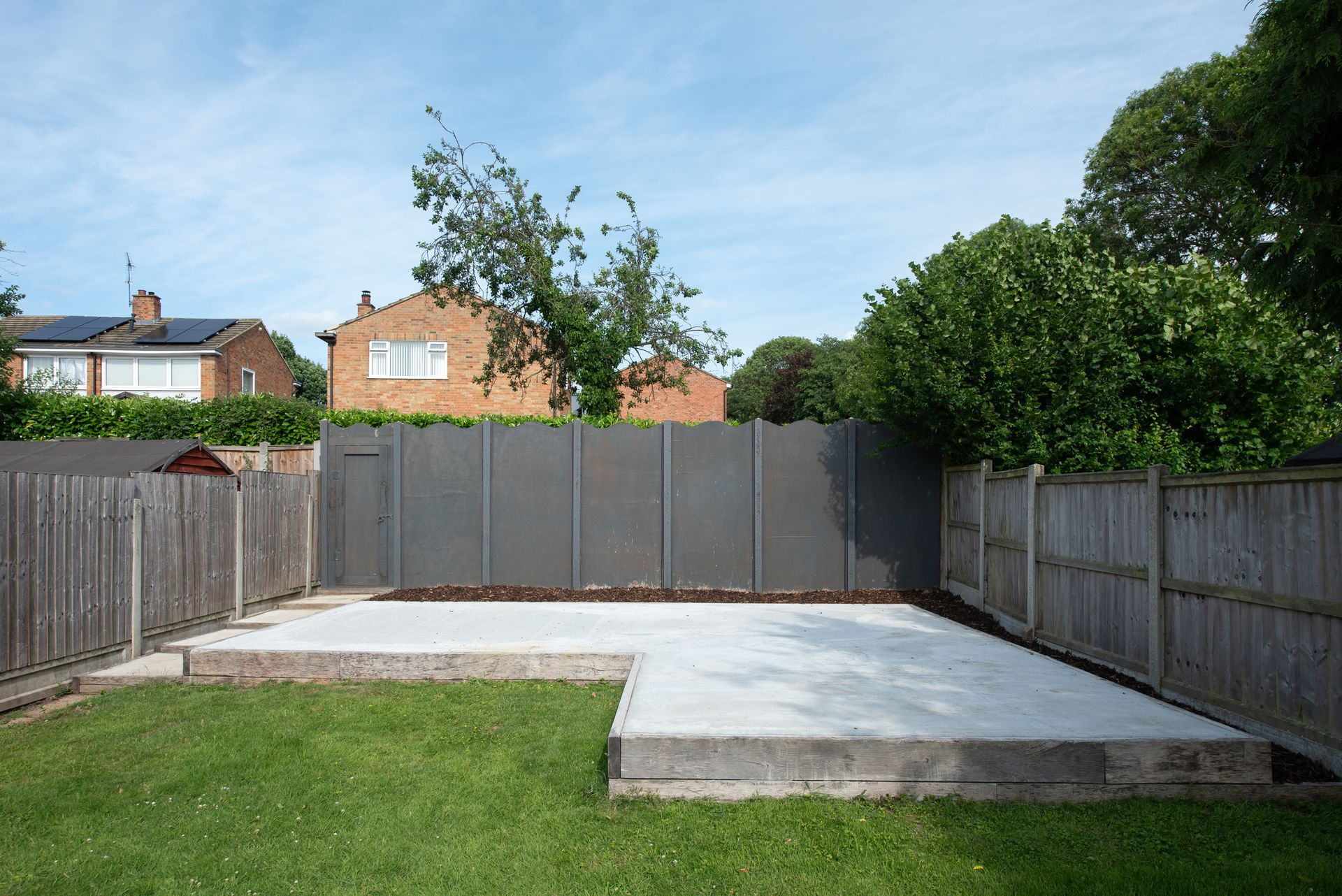 A patio with chairs , a table , and an umbrella.