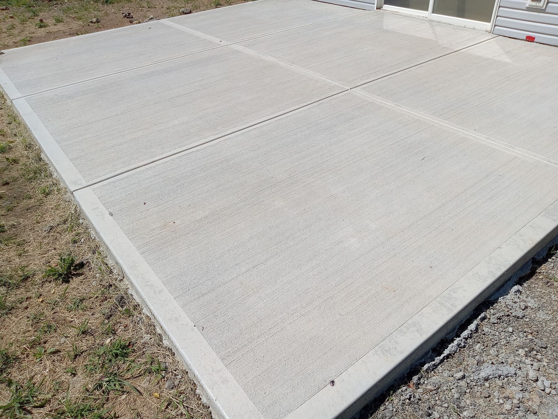Two chairs and a table are sitting on a patio.