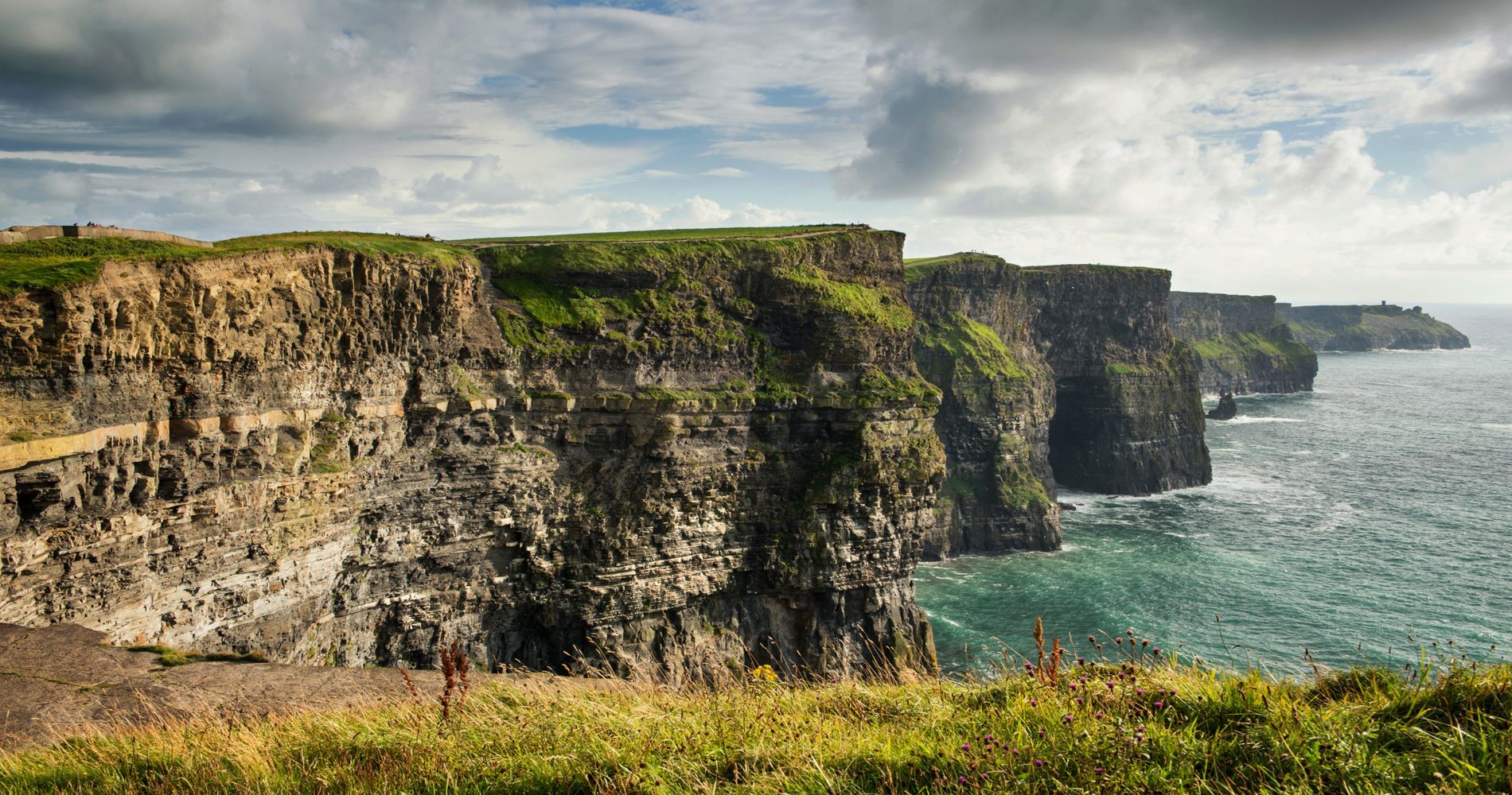 A view of a cliff overlooking a body of water.