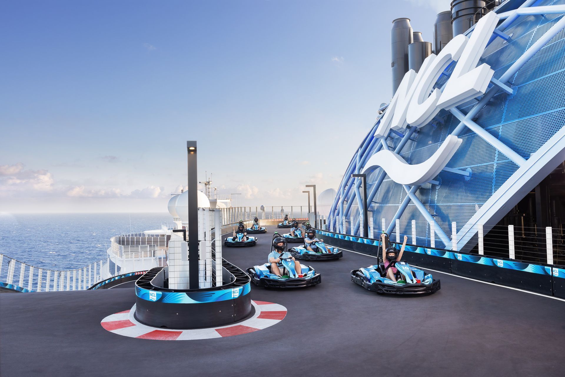 A group of people are riding go karts on a cruise ship.