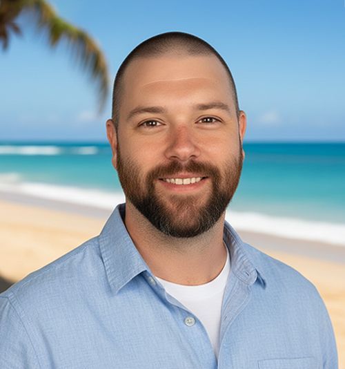 Abraham with a beard smiling, wearing a black shirt, in front of a tropical beach scene.