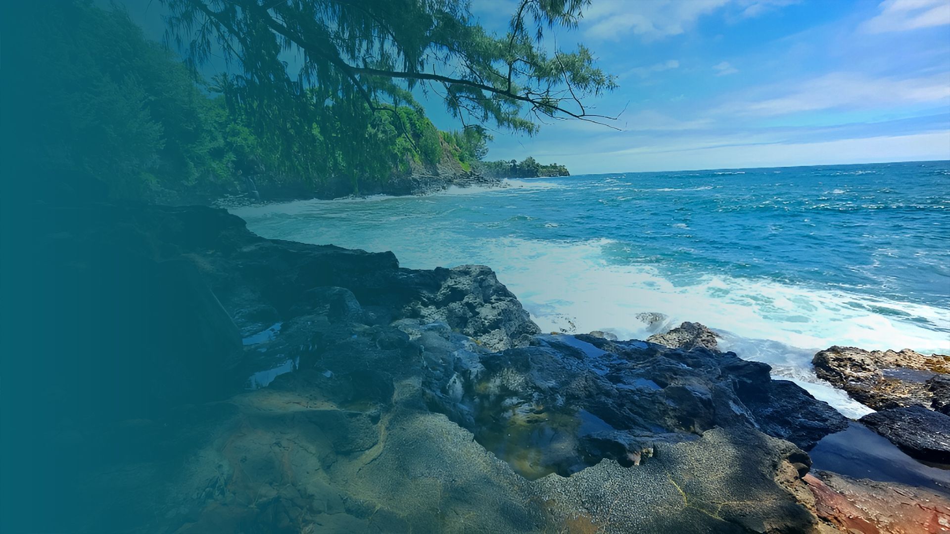  A rocky shoreline with waves crashing dramatically against the rocks under a clear blue sky.
