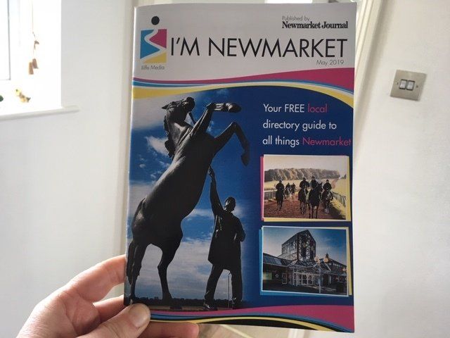 A person is holding a book titled i 'm newmarket