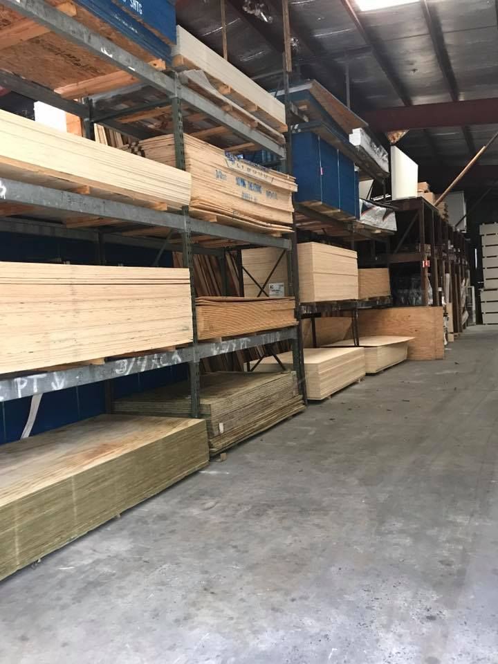 A warehouse filled with lots of wooden boards on shelves.