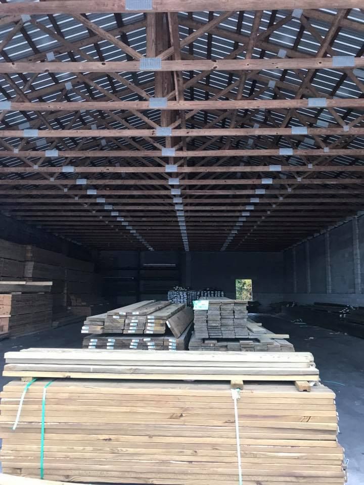 A large warehouse filled with lots of wooden boards.