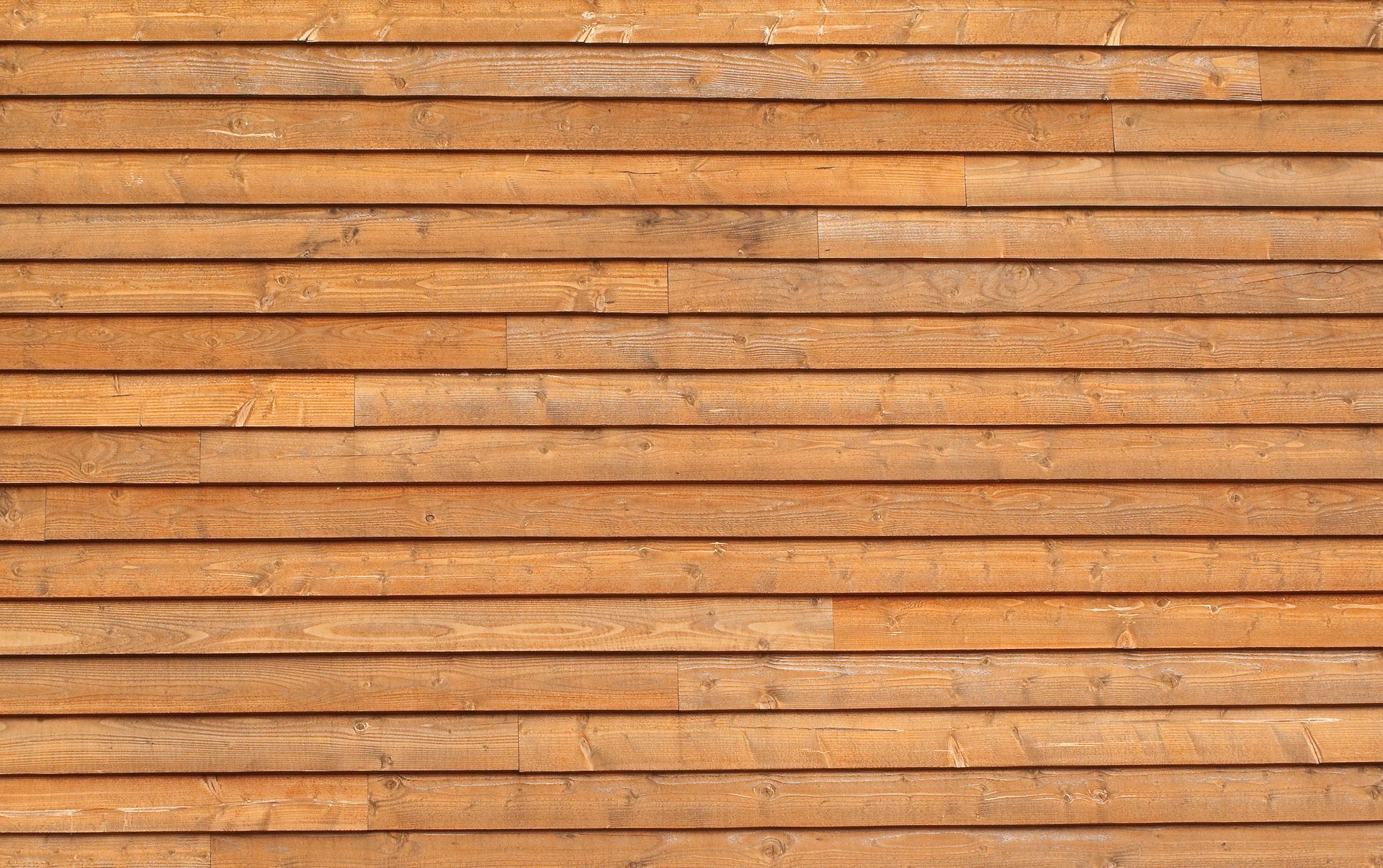 Wooden planks, horizontally arranged, with varying shades of brown and visible wood grain.