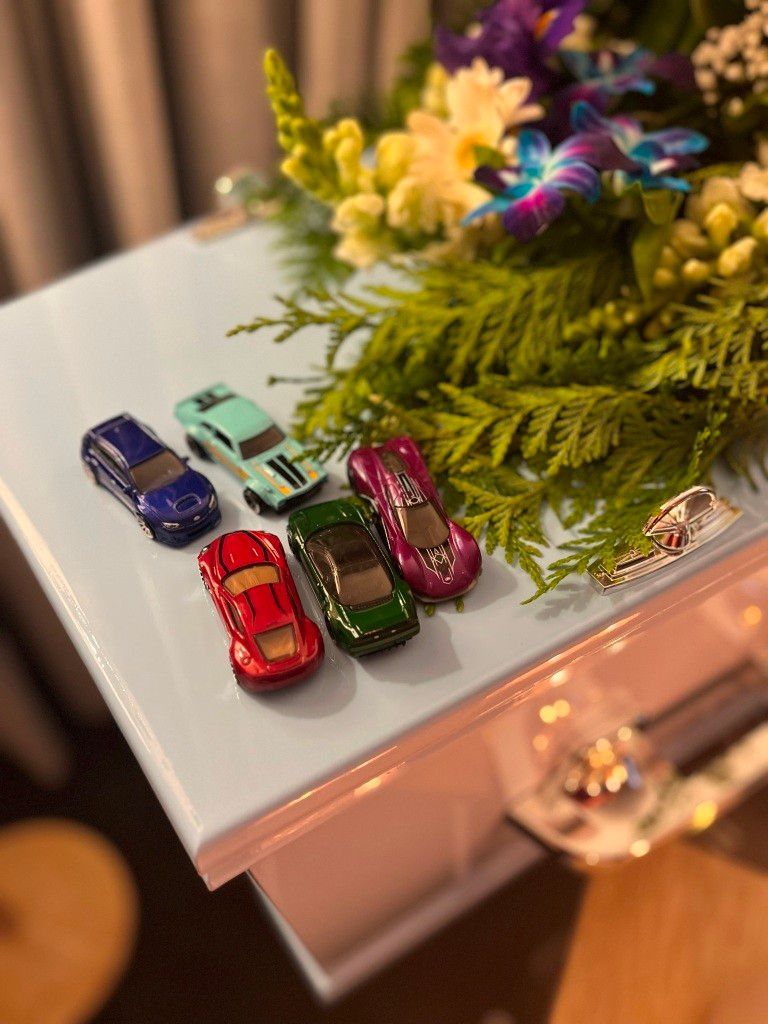 Image of a Baby Coffin with Toy cars on it