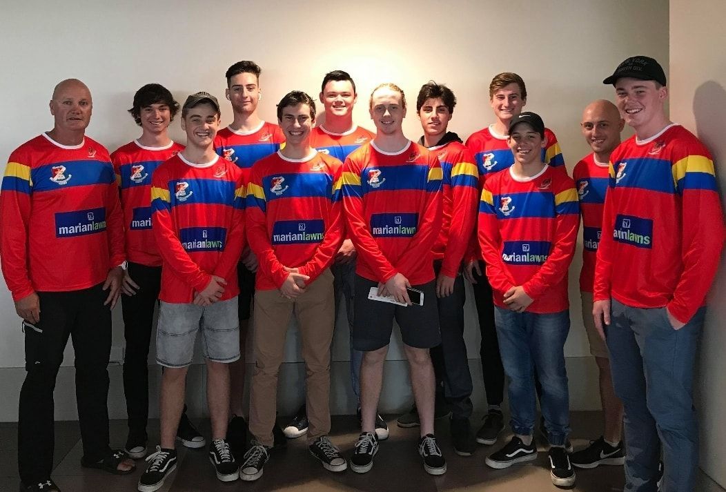A Group Of People Wearing Red And Blue Shirts Are Posing For A Picture — Marian Lawns In Marian, QLD