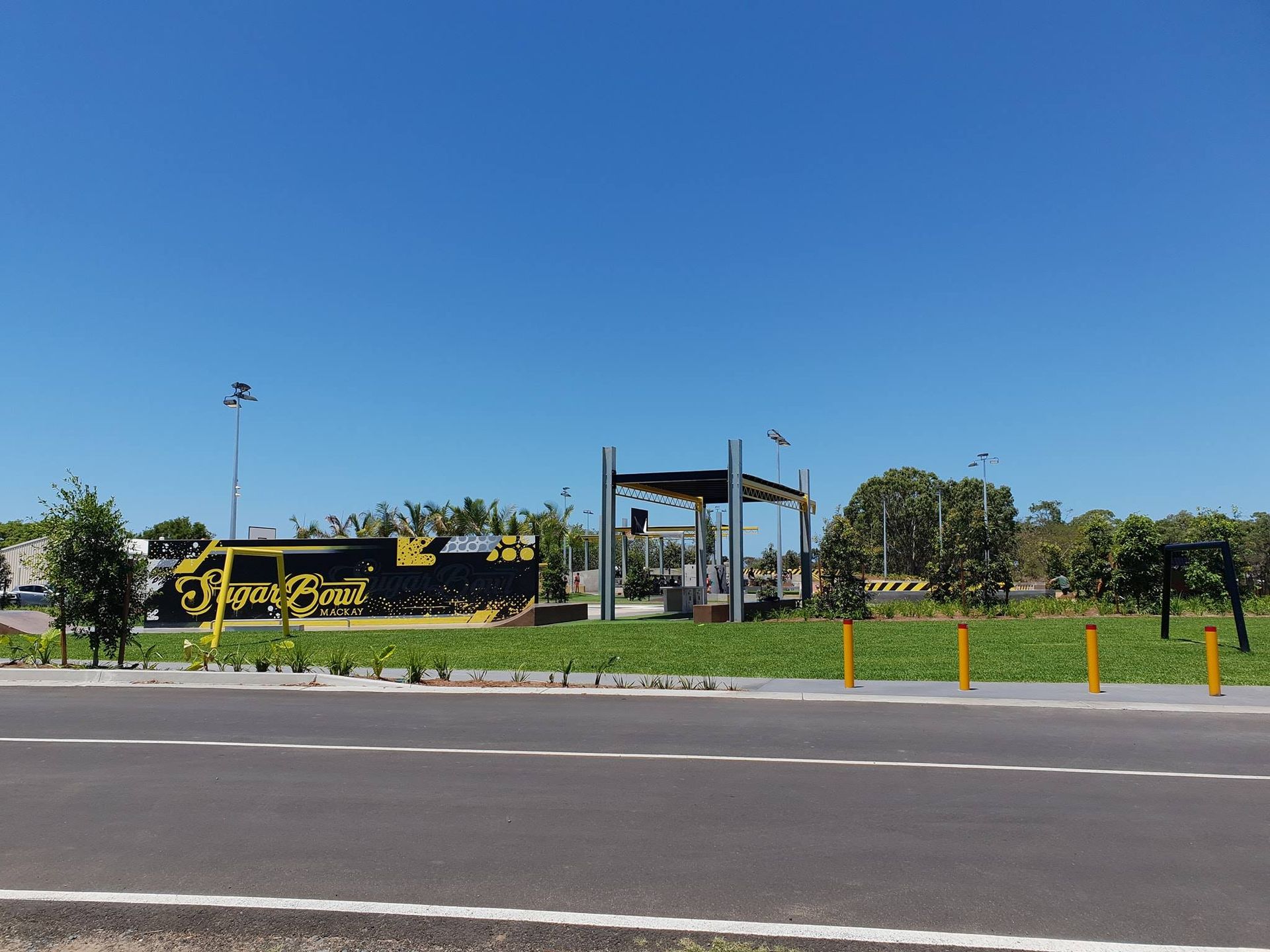 A Field Of Green Plants With Mountains In The Background — Marian Lawns In Proserpine, QLD