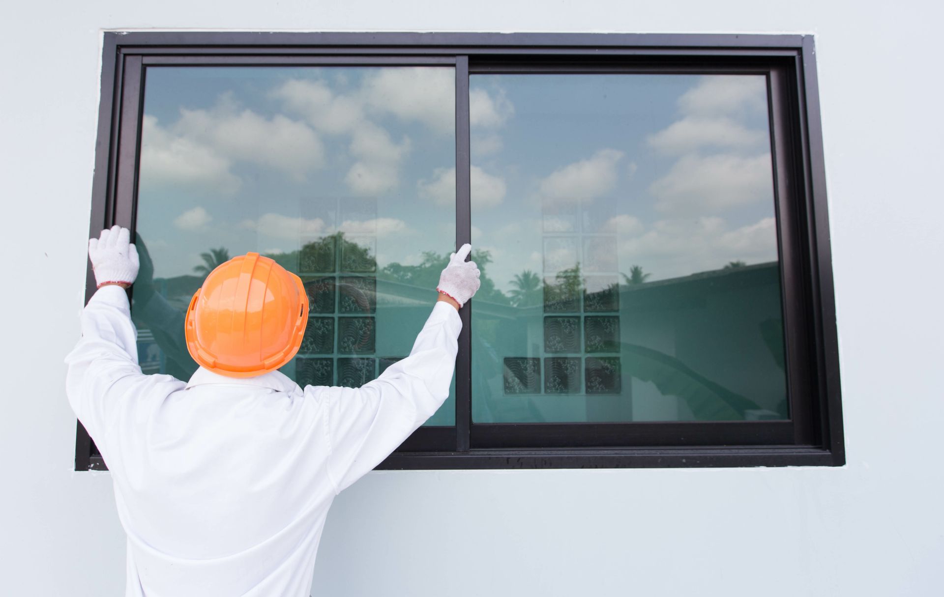 Skilled technician's hands installing aluminum windows with precision.