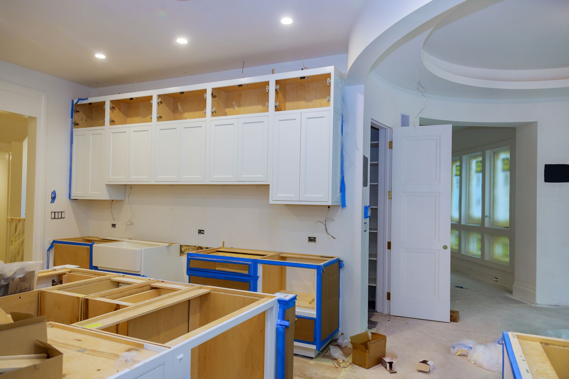Newly installed white kitchen cabinets in a newly constructed house.