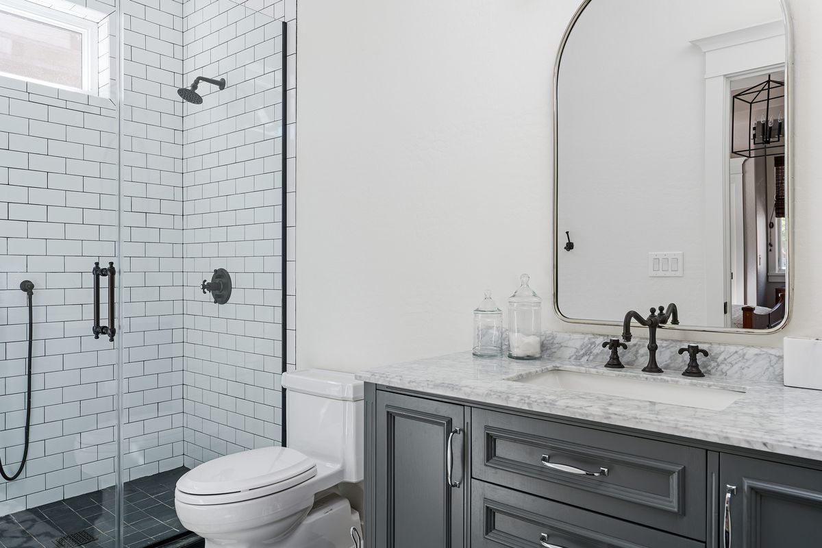 A black and white bathroom with modern fixtures, sleek lines, and a pristine look.