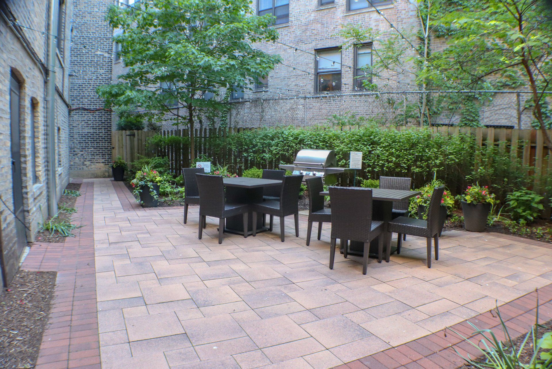 Reside at 849 outdoor patio with tables and chairs and a grill.