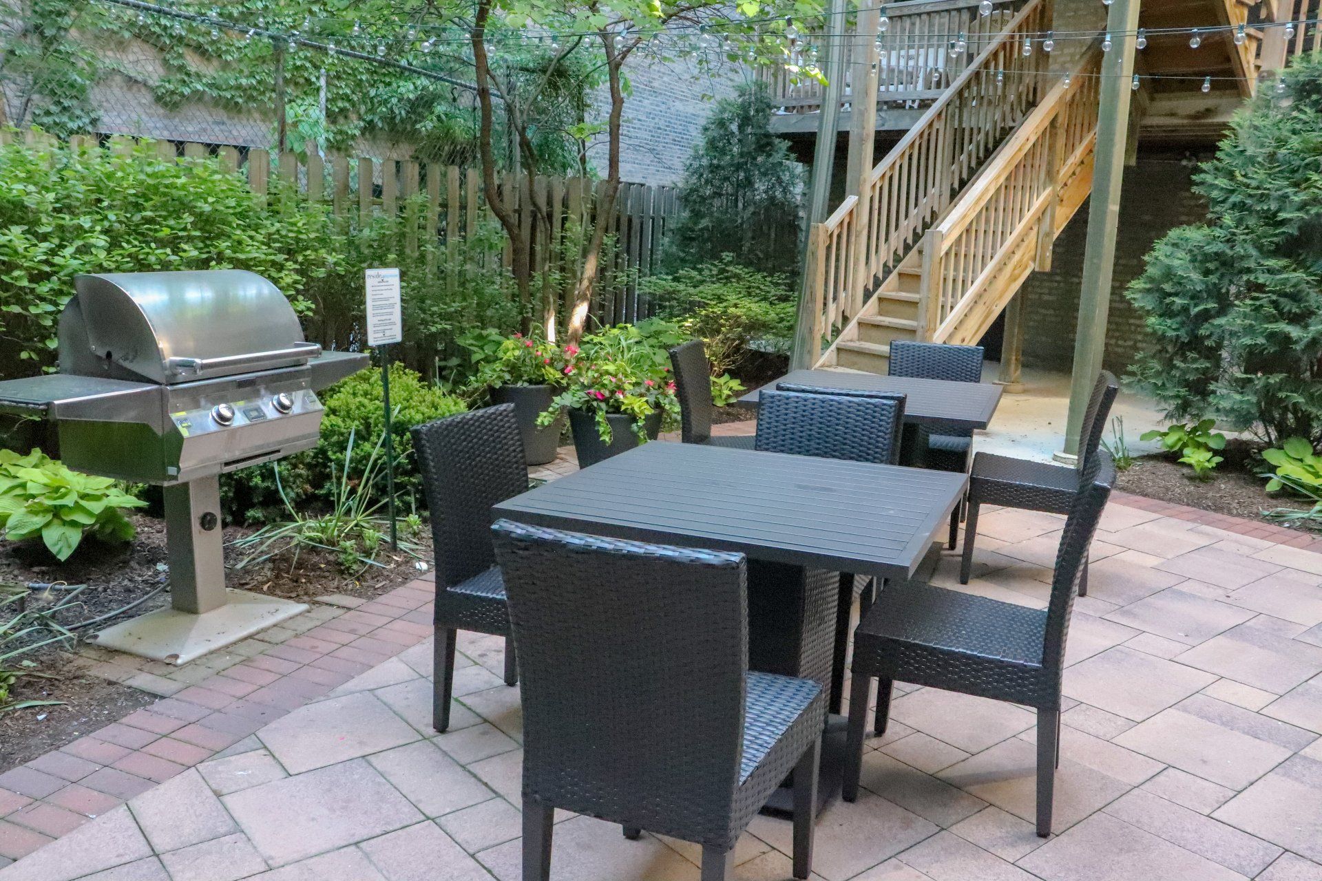 An outdoor patio with a table and chairs and a grill at Reside at 849.