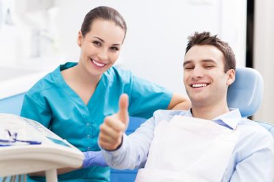 Dental Injuries — Man Giving Thumbs Up at Dentist Office in Cumming, GA