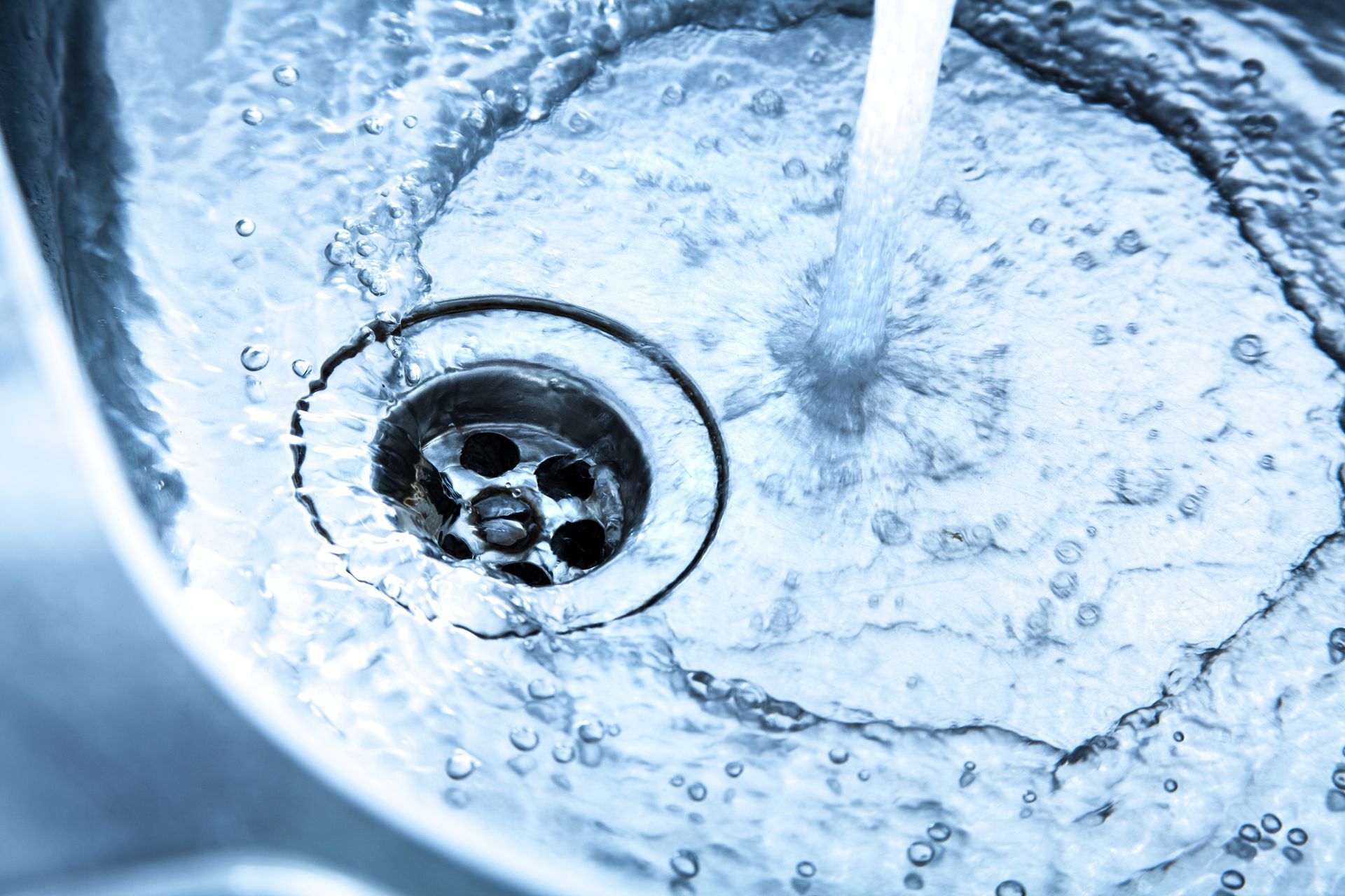 A close-up of a sink drain Cleaning